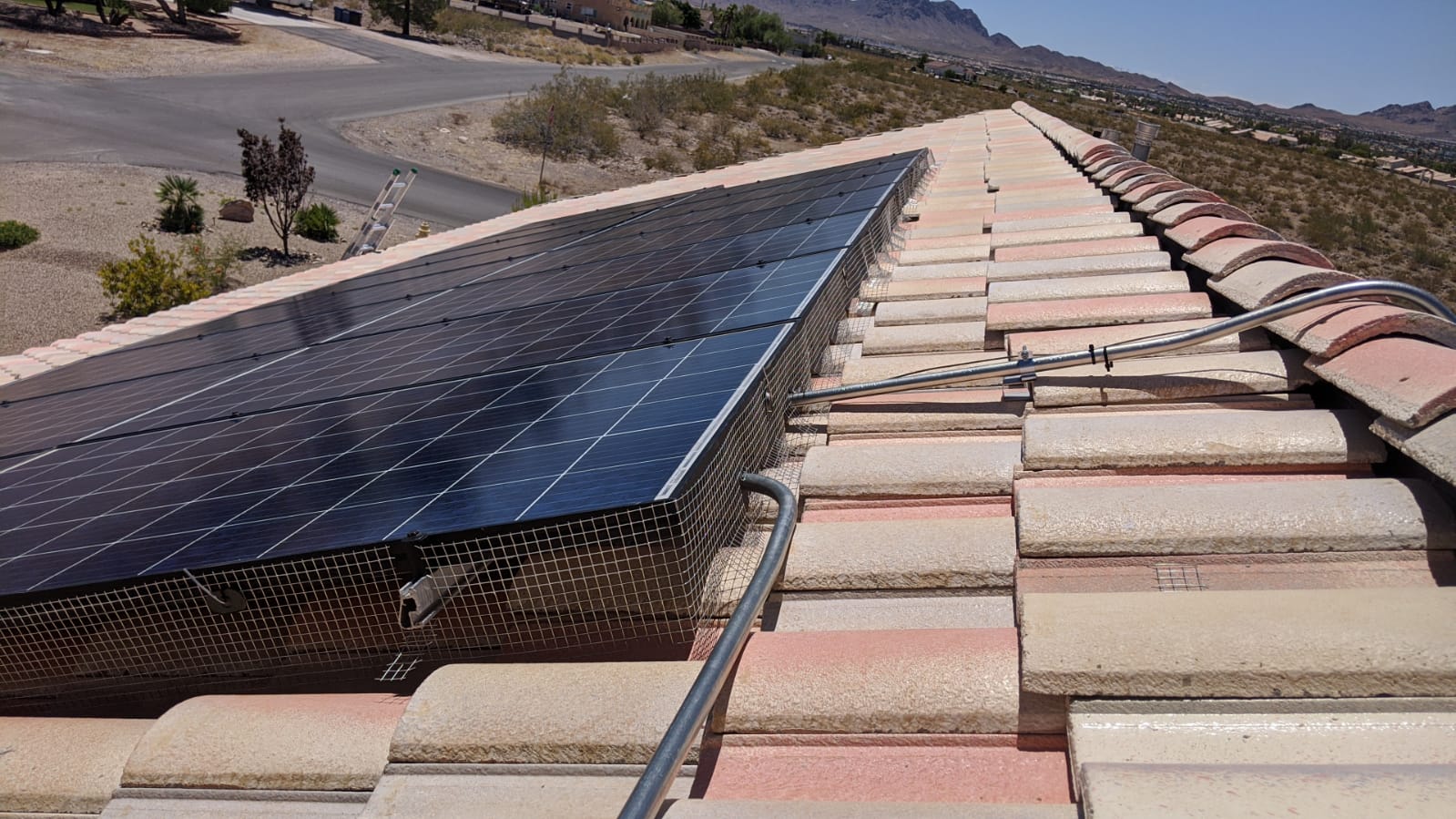 Critter guard installed around rooftop solar panels