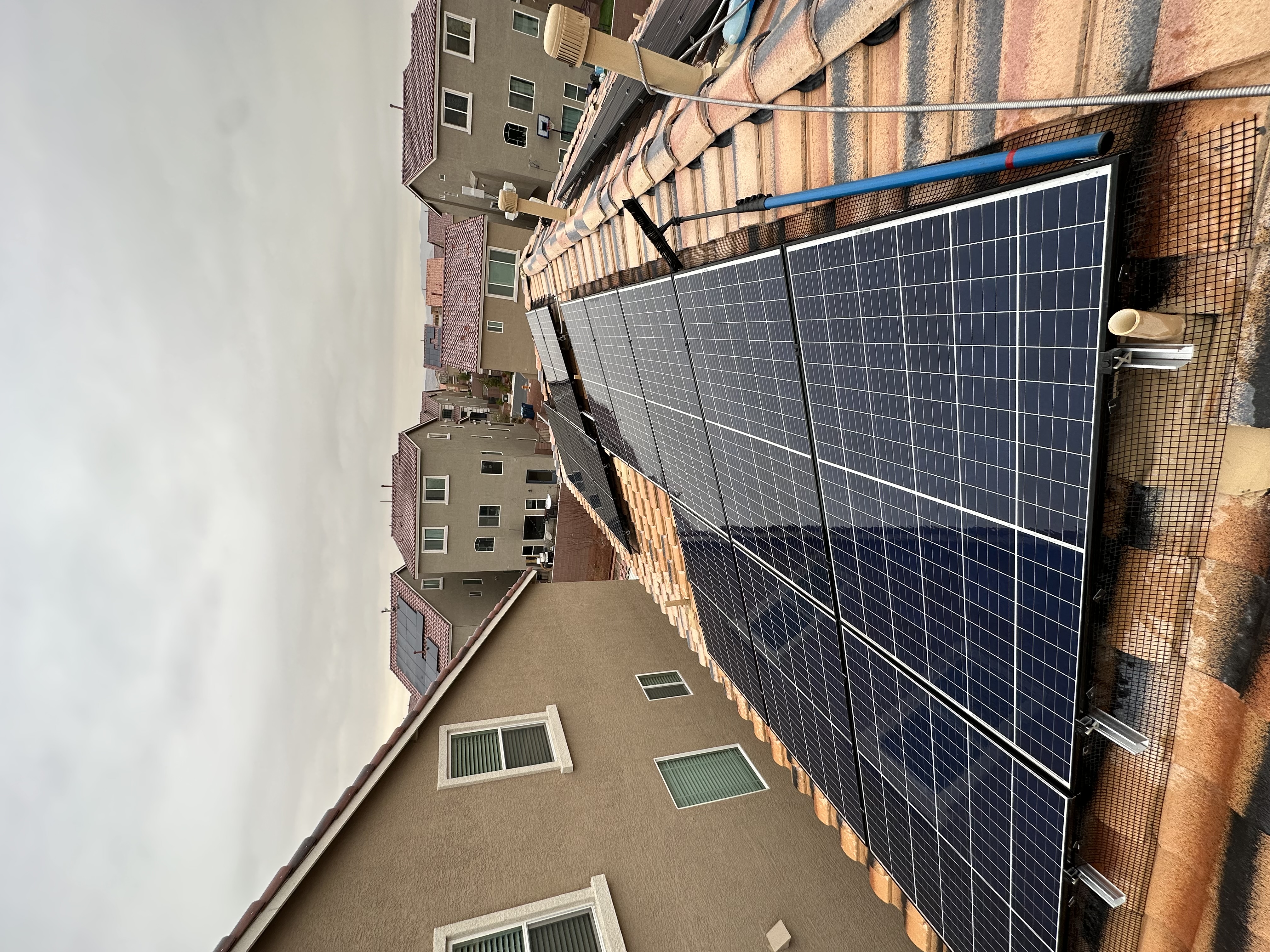 Clean solar panels on a Henderson rooftop with mountain views in the background